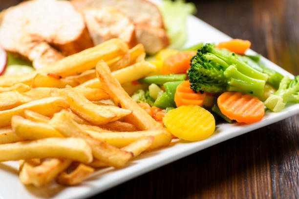 Tasty stir-fried beef and vegetables with french fries served in restaurant