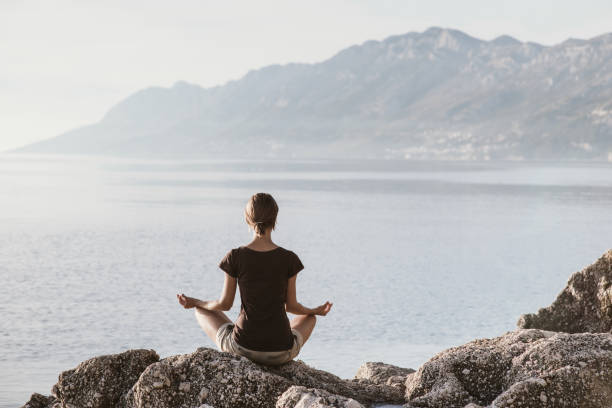 istock Woman is practicing yoga outdoors. Meditation and harmony concept 1066562860