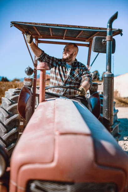 istock Tractor Driver Salutes His Colleagues 1066563540