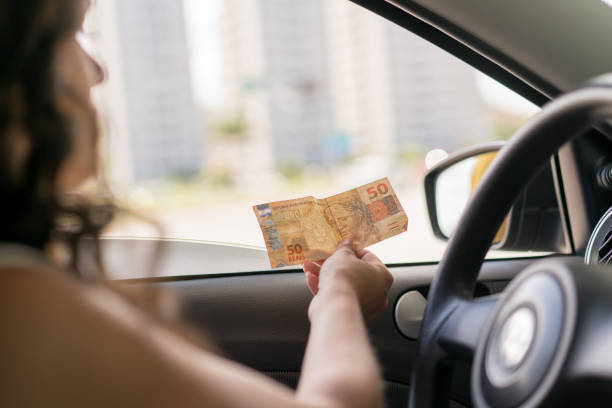 Woman paying cash in the gas station Gas Station, Driving, Paying, Gasoline, City Street cash in transit vehicle stock pictures, royalty-free photos & images
