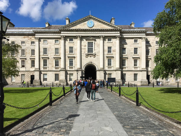 Regent House building at Trinity College in Dublin, Ireland DUBLIN, LEINSTER, IRELAND - MAY 13, 2018: Regent House at Trinity College under a blue sky in a sunny day. Students access through it to Parliament Square, Book of Kells, and the university buildings. trinity college library stock pictures, royalty-free photos & images