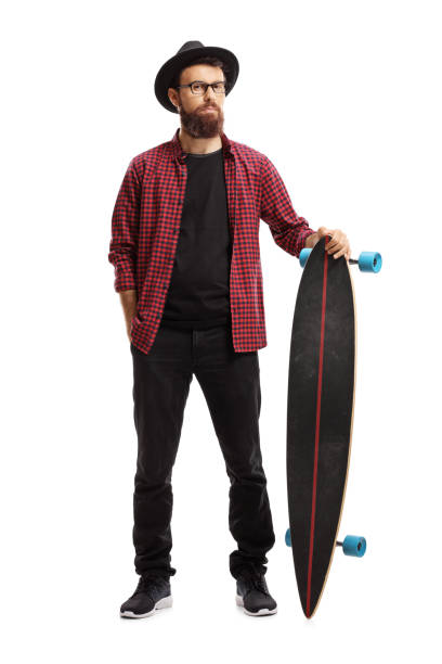 istock Male hipster standing and holding a longboard 1066572806