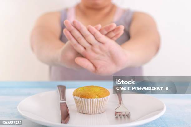 Fat Woman Rejecting Cupcake Or Unhealthy Food Health Care Concept Stock Photo - Download Image Now