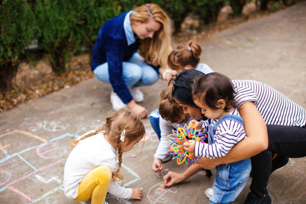 istock Girls drawing hopscotch 1066578944