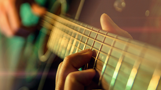 Play the guitar, man is playing the guitar, close up