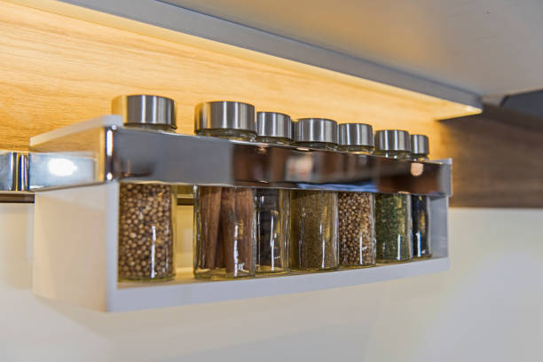 Spice jars on a wall rack stock photo