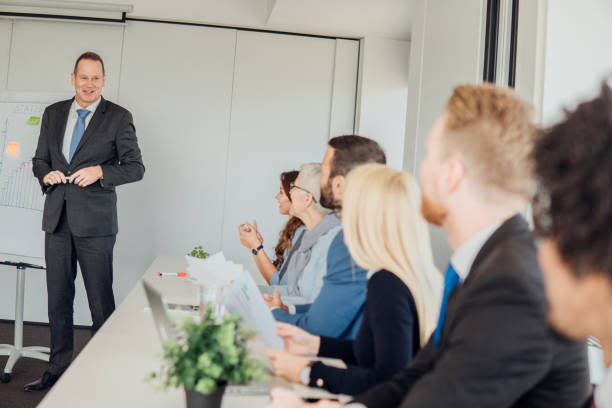 istock Business man looking at his coworkers 1066581996