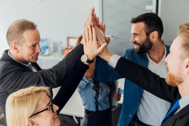 istock People smiling when giving each other high five 1066582184
