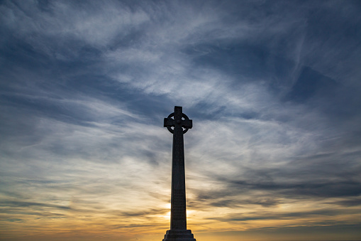 Tennyson Monument on the Isle of Wight, silhouetted at sunset