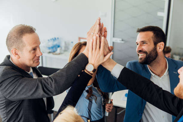 istock Smiling coworkers giving each other high five 1066584652