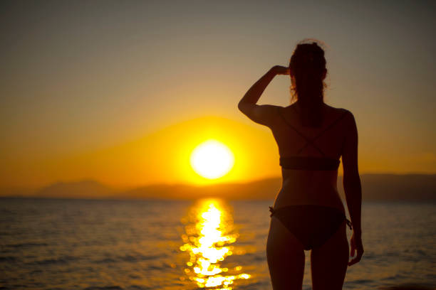 istock Woman enjoying beautiful suset 1066585710