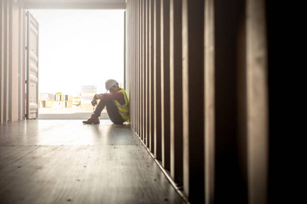 wanhoop personeel in logistieke bedrijf sittng in container - moe stockfoto's en -beelden