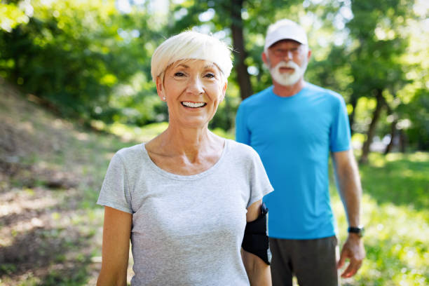istock Happy fit senior couple exercising in park 1066593596