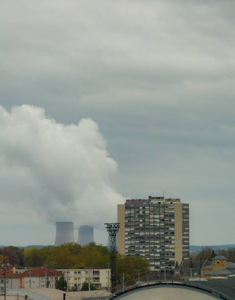 istock Urban view with power plant with steaming cooling towers 1066594418