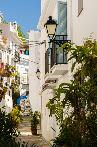 beautiful and picturesque narrow street with white facades of buildings, Spanish architecture, old town