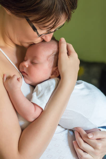 istock The newborn sleeps on his mother's chest 1066597796