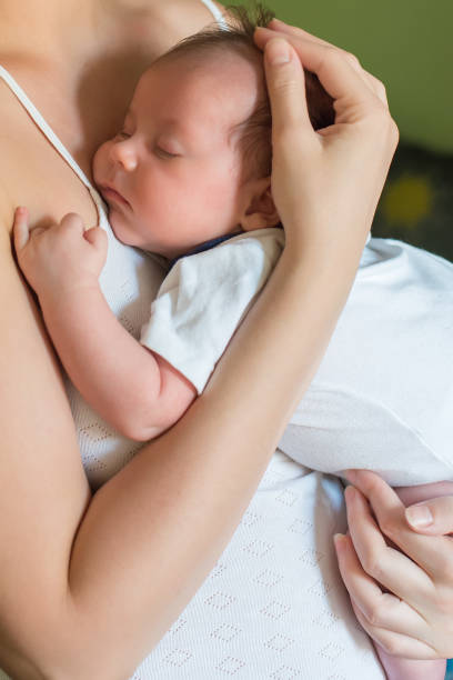 istock The newborn sleeps on his mother's chest 1066598070