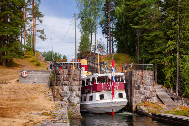 EIDSFOSS, NORWAY - JULY 18, 2018: M/S Henrik Ibsen ferry boat entering lock chamber at the Eidsfoss lock during a unique historical boat trip through spectacular Norwegian nature by the Telemark Canal