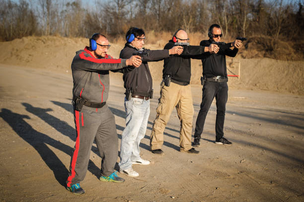 istock Group of people practice gun shooting on outdoor shooting range 1066603616