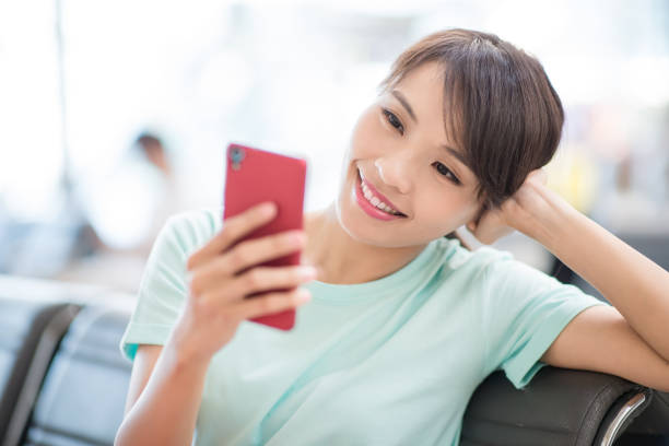 istock woman use phone happily 1066603684