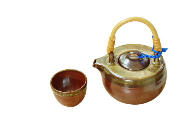 istock pottery tea pot and glass on white background 1066603980