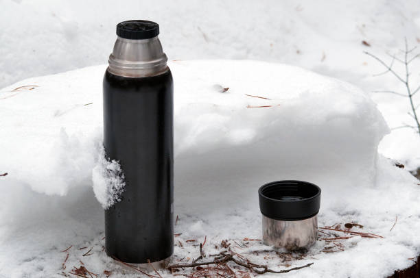 istock Thermos with open cup on the snow 1066605674