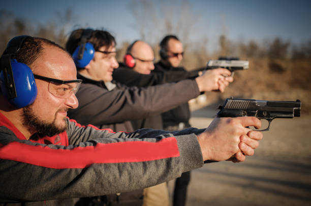 istock Group of people practice gun shooting on outdoor shooting range 1066606732