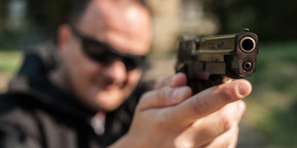 istock Police agent bodyguard gun pointing pistol to attacker. Front view 1066608522