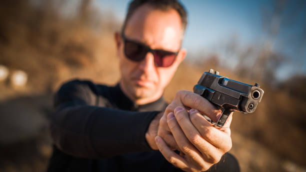 istock Police agent bodyguard gun pointing pistol to attacker. Front view 1066609560