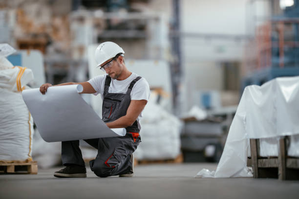 istock Engineer with blueprint in factory 1066612342