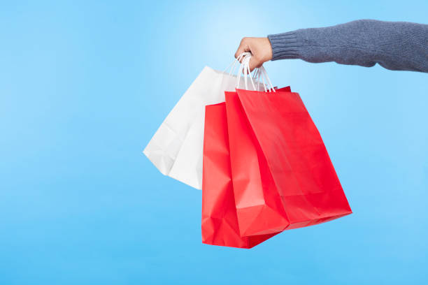 istock Man's hand with shopping bags. 1066614760