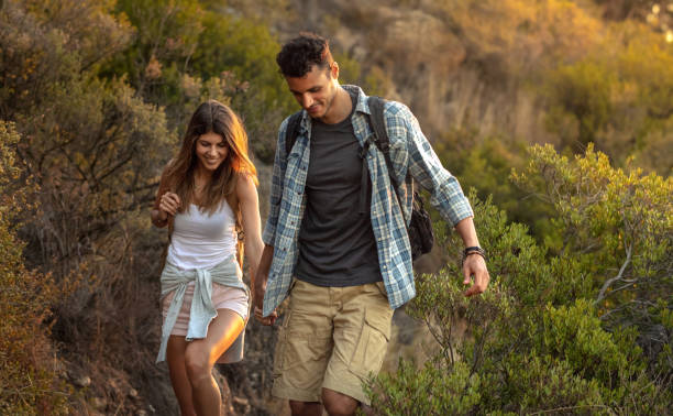 istock Young couple hiking together at hill side 1066615020