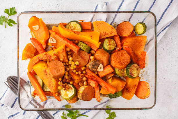 istock Baked vegetables with chickpeas in glass dish, top view. 1066615638