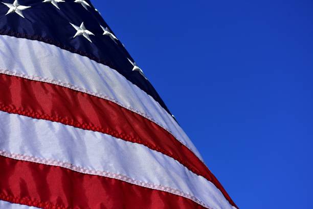 istock American Flag Against The Deep Blue Sky 1066615646