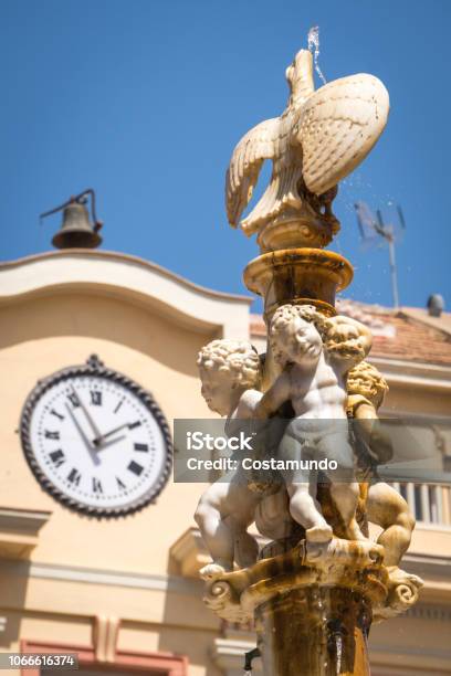 Statue Plaza De La Constitucion Malaga Stock Photo - Download Image Now - Andalusia, Angel, Clock