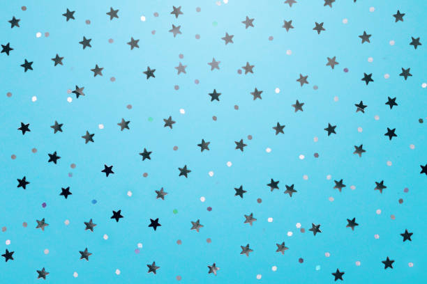 istock Christmas pattern made of silver stars on blue background. Winter concept. Flat lay. 1066619100