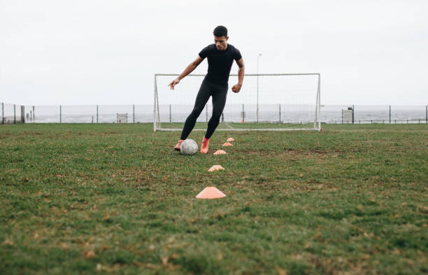 istock Soccer player practicing dribbling with the help of cones 1066619398