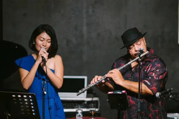 Photo of Multi-ethnic jazz music group performing at stage