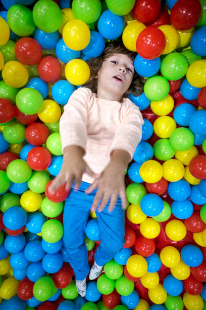 istock Cute Little boy playing at colorful plastic balls playground. 1066620488