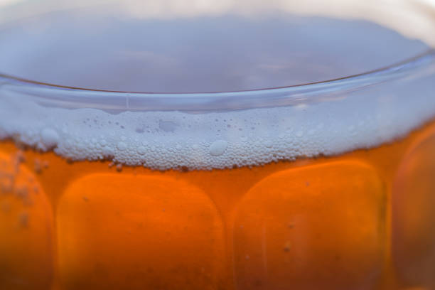 Froth of beer at brim of glass
