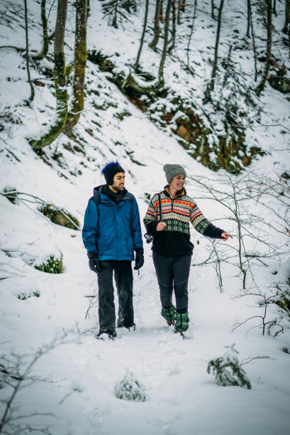 istock Couple walks through wintery forest 1066622068
