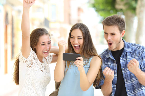 istock Excited friends watching media from smartphone 1066622152