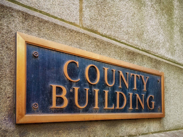 Exterior sign that reads "County Building" in brass letters. stock photo