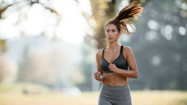 istock Young woman jogging in park 1066625866