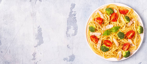 istock Plate of spaghetti tomato broccoli chicken 1066629252