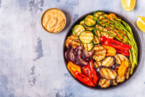 istock Grilled vegetables on a plate with sauce 1066630076