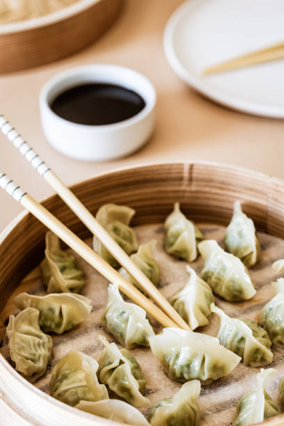 istock Asian gyoza, dumplings snack, chopsticks, steamer 1066630536