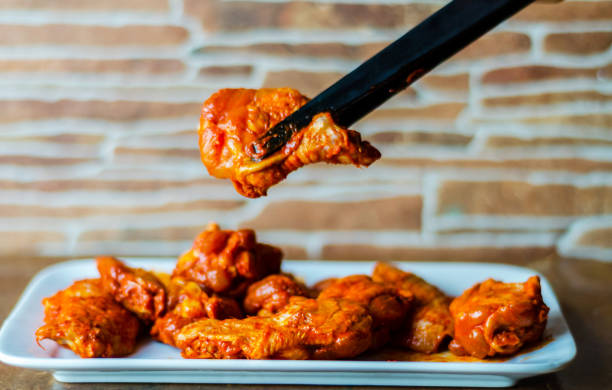 istock chicken wings marinated in a barbecue sauce, a typical American snack, 1066631854