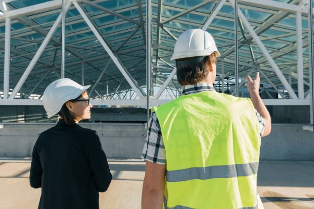istock Man engineer and woman architect at a construction site. Building, development, teamwork and people concept 1066632046