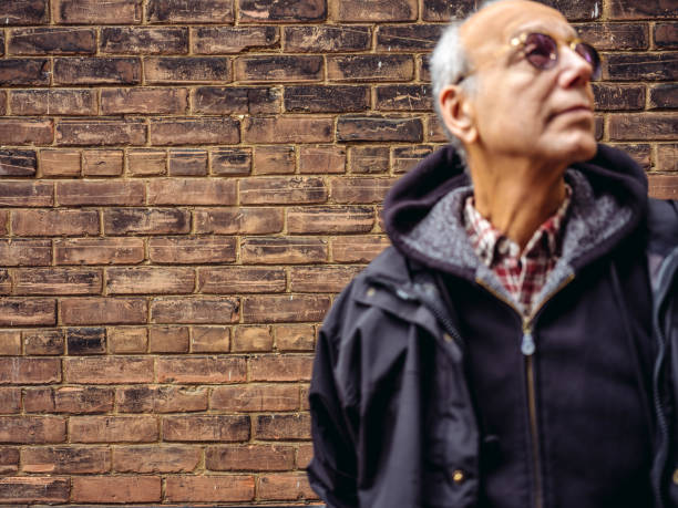 istock Senior man in front of brick wall 1066636342